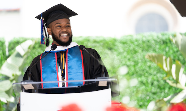Headshot of Obioma at commencement 2023 standing at a podium.
