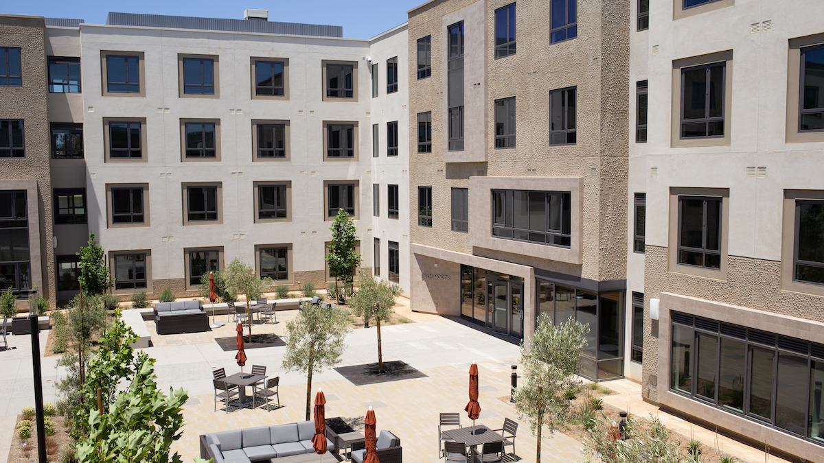 Exterior shot of Palm North. patio is visible adjacent to building.